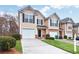 Charming townhome with a well-manicured lawn and single-car garage and inviting curb appeal at 3682 Harvest Dr, Decatur, GA 30034