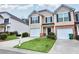 Inviting two-story townhome with a manicured lawn, an attached garage and dark shutters at 3682 Harvest Dr, Decatur, GA 30034