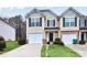 Inviting two-story townhome with a well-manicured lawn, single-car garage, and dark shutters at 3682 Harvest Dr, Decatur, GA 30034