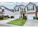 Beautiful townhome with a single-car garage, lush lawn, and freshly updated neutral siding at 3682 Harvest Dr, Decatur, GA 30034