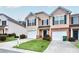 Inviting townhome features a well-manicured lawn, a one-car garage, and a charming front entrance at 3682 Harvest Dr, Decatur, GA 30034