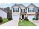 Inviting townhome features a well-manicured lawn, a one-car garage, and a charming front entrance at 3682 Harvest Dr, Decatur, GA 30034