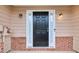 Beautiful front door with white trim, brick accents, and overhead lighting at 3682 Harvest Dr, Decatur, GA 30034