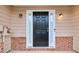 Home exterior featuring a black front door and brick detail at 3682 Harvest Dr, Decatur, GA 30034