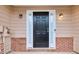 Close up of black front door flanked by sidelights with brick and beige siding at 3682 Harvest Dr, Decatur, GA 30034