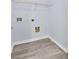 A well-lit laundry room with gray vinyl plank floors and a wire shelf above the washing machine hookups at 3682 Harvest Dr, Decatur, GA 30034