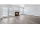 Sunlit living room boasts wood-look floors, a cozy fireplace, and French doors to backyard at 3682 Harvest Dr, Decatur, GA 30034