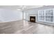 Spacious living room with a fireplace, large windows, and sleek laminate flooring at 3682 Harvest Dr, Decatur, GA 30034