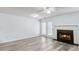 Bright living room featuring wood-look floors, a fireplace, ceiling fan, and access to outdoor patio space at 3682 Harvest Dr, Decatur, GA 30034