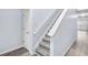 Bright, modern staircase with gray carpet, white risers, and gray-tone wood flooring at 3682 Harvest Dr, Decatur, GA 30034