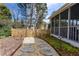 Landscaped backyard featuring a stepping stone path and screened-in porch at 720 First Cotton Dr, Powder Springs, GA 30127