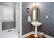 Charming powder room with floral wallpaper, pedestal sink, and natural light for a vintage touch at 720 First Cotton Dr, Powder Springs, GA 30127