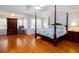 Bedroom with wooden floors, four poster bed, and natural light at 720 First Cotton Dr, Powder Springs, GA 30127