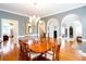 Elegant dining room featuring hardwood floors, chandelier, and arched doorways for a refined living experience at 720 First Cotton Dr, Powder Springs, GA 30127