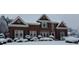 Beautiful home exterior during winter, with a brick facade adorned with wreaths and a snow-covered front yard at 720 First Cotton Dr, Powder Springs, GA 30127