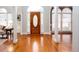 Bright foyer with shiny hardwood floors, elegant archways, and a decorative front door at 720 First Cotton Dr, Powder Springs, GA 30127