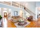 Inviting living room with two-story ceiling, staircase, and hardwood floors, creating an open and airy atmosphere at 720 First Cotton Dr, Powder Springs, GA 30127