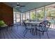 Relaxing screened porch with brick accent wall and comfortable seating at 720 First Cotton Dr, Powder Springs, GA 30127