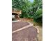 View of a multi-level backyard featuring a wooden deck, mulch ground cover, and a retaining wall at 1759 Wilmont Ne Dr, Atlanta, GA 30329