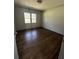 Empty bedroom with hardwood floors and a large window for natural light at 1759 Wilmont Ne Dr, Atlanta, GA 30329