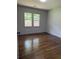 Bedroom featuring hardwood floors, fresh paint, and natural light from two large windows at 1759 Wilmont Ne Dr, Atlanta, GA 30329