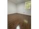 A cozy room features gleaming hardwood floors and a bright window for natural light at 1759 Wilmont Ne Dr, Atlanta, GA 30329