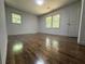 Bright bedroom featuring hardwood floors, fresh paint, and natural light from two large windows at 1759 Wilmont Ne Dr, Atlanta, GA 30329