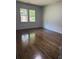 Bedroom featuring hardwood floors, fresh paint, and natural light from two large windows at 1759 Wilmont Ne Dr, Atlanta, GA 30329