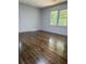 Bedroom featuring hardwood floors, fresh paint, and natural light from two large windows at 1759 Wilmont Ne Dr, Atlanta, GA 30329