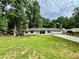 Ranch-style home with a well-manicured lawn, mature trees and a long driveway at 1759 Wilmont Ne Dr, Atlanta, GA 30329