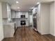 Modern kitchen with white cabinets, stainless steel appliances, and hardwood floors at 1759 Wilmont Ne Dr, Atlanta, GA 30329