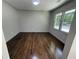 Empty room featuring hardwood floors and large windows allowing ample sunlight at 1759 Wilmont Ne Dr, Atlanta, GA 30329