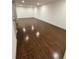 A spacious room features gleaming hardwood floors, white walls, and a doorway at 1759 Wilmont Ne Dr, Atlanta, GA 30329