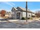 Charming home featuring a gray brick facade, a gable roof, and a concrete perimeter at 235 Dodd Sw Ave, Atlanta, GA 30315