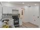 Bright kitchen featuring white cabinets, granite countertops, and stainless steel appliances next to hookups at 235 Dodd Sw Ave, Atlanta, GA 30315