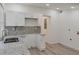 Bright kitchen features white cabinets, granite countertops and stainless steel sink at 235 Dodd Sw Ave, Atlanta, GA 30315