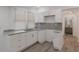 A bright kitchen features granite countertops, light wood floors, and all-white cabinets at 235 Dodd Sw Ave, Atlanta, GA 30315