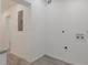 Empty room featuring washer and dryer hookups, electrical panel, and white walls at 235 Dodd Sw Ave, Atlanta, GA 30315