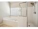 Bright bathroom with jacuzzi tub, tiled floors, and enclosed shower at 3915 Northridge Dr, Cumming, GA 30040