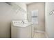 Well-lit laundry room with a side-by-side washer and dryer and a metal storage rack at 3915 Northridge Dr, Cumming, GA 30040