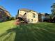 Expansive backyard featuring a wooden deck with stairs descending to the lush green lawn at 2741 Willowstone Dr, Duluth, GA 30096