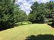 A well-maintained, spacious backyard featuring a lush lawn and mature trees at 2741 Willowstone Dr, Duluth, GA 30096