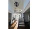 Grand two-story foyer with hardwood floors, staircase, and elegant lighting at 2741 Willowstone Dr, Duluth, GA 30096