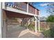 Backyard patio beneath wooden deck, showcasing outdoor living space and a fenced yard at 513 Mirramont Pl, Woodstock, GA 30189