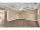 Spacious bedroom featuring hardwood floors and decorative tray ceiling with ceiling fan at 513 Mirramont Pl, Woodstock, GA 30189