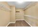 Walk-in closet offering ample storage with multiple shelves and hardwood floors at 513 Mirramont Pl, Woodstock, GA 30189
