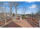 Spacious wooden deck with a railing, offering scenic neighborhood views and outdoor enjoyment at 513 Mirramont Pl, Woodstock, GA 30189