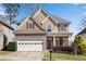 Charming two-story home with stone accents, red shutters, attached two-car garage, and well-maintained lawn at 513 Mirramont Pl, Woodstock, GA 30189