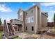 View of the two-story home featuring a deck, walkout basement, and backyard patio at 513 Mirramont Pl, Woodstock, GA 30189
