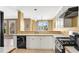 Spacious kitchen boasts white cabinets, stainless appliances, and an open design at 513 Mirramont Pl, Woodstock, GA 30189